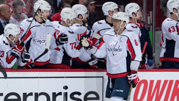 DETROIT, MI - NOVEMBER 30: Alex Ovechkin #8 of the Washington Capitals pounds gloves with teammates on the bench following his third goal of the game during the third period of an NHL game against the Detroit Red Wings at Little Caesars Arena on November 30, 2019 in Detroit, Michigan. The Capitals defeated the Wings 5-2. (Photo by Dave Reginek/NHLI via Getty Images)