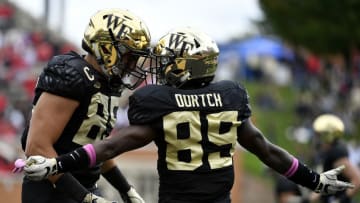 WINSTON SALEM, NC - OCTOBER 28: Wide receiver Greg Dortch #89 celebrates with tight end Cam Serigne #85 of the Wake Forest Demon Deacons after scoring a touchdown against the Louisville Cardinals late in the first quarter of the football game at BB&T Field on October 28, 2017 in Winston Salem, North Carolina. (Photo by Mike Comer/Getty Images)