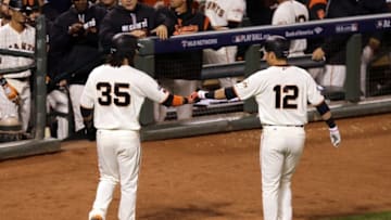 Oct 11, 2016; San Francisco, CA, USA; San Francisco Giants shortstop Brandon Crawford (35) and San Francisco Giants second baseman Joe Panik (12) celebrate after scoring during the fifth inning of game four of the 2016 NLDS playoff baseball game against the Chicago Cubs at AT&T Park. Mandatory Credit: Kelley L Cox-USA TODAY Sports
