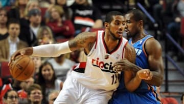 April 12, 2013; Portland, OR, USA; Portland Trail Blazers power forward LaMarcus Aldridge (12) dribbles the ball in on Oklahoma City Thunder power forward Serge Ibaka (9) during the first quarter of the game at the Rose Garden. Mandatory Credit: Steve Dykes-USA TODAY Sports