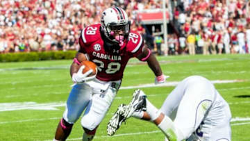 Oct 18, 2014; Columbia, SC, USA; South Carolina Gamecocks running back Mike Davis (28) leaves behind Furman Paladins defensive end Gary Wilkins (35) on his way to a touchdown in the first quarter at Williams-Brice Stadium. Mandatory Credit: Jeff Blake-USA TODAY Sports