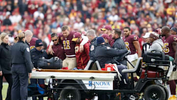 LANDOVER, MD - NOVEMBER 18: Alex Smith #11 of the Washington Redskins is helped off the field after being sacked and injured by Kareem Jackson #25 of the Houston Texans in the third quarter of the game at FedExField on November 18, 2018 in Landover, Maryland. (Photo by Joe Robbins/Getty Images)