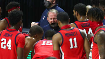 Jan 12, 2021; Gainesville, Florida, USA;Mississippi Rebels head coach Kermit Davis huddles up with teammates against the Florida Gators during the second half at Billy Donovan Court at Exactech Arena. Mandatory Credit: Kim Klement-USA TODAY Sports