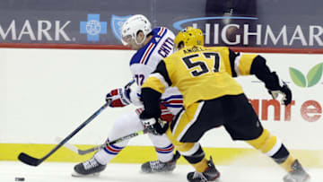Mar 9, 2021; Pittsburgh, Pennsylvania, USA; New York Rangers center Filip Chytil (72) moves the puck against Pittsburgh Penguins center Anthony Angello (57) during the third period at PPG Paints Arena. Mandatory Credit: Charles LeClaire-USA TODAY Sports
