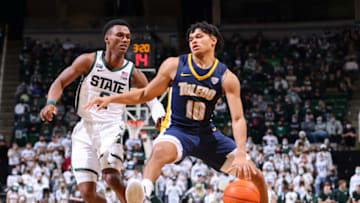 Toledo Rockets guard RayJ Dennis drives past Michigan State guard Tyson Walker. Getty Images.