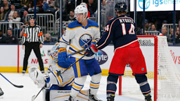 Dec 7, 2022; Columbus, Ohio, USA; Buffalo Sabres goalie Ukko-Pekka Luukkonen (1) makes a save as Columbus Blue Jackets center Gustav Nyquist (14) looks for a rebound during the second period at Nationwide Arena. Mandatory Credit: Russell LaBounty-USA TODAY Sports