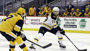 Mar 16, 2021; Pittsburgh, Pennsylvania, USA; Boston Bruins defenseman Charlie McAvoy (73) skates with the puck against Pittsburgh Penguins center Colton Sceviour (7) during the second period at PPG Paints Arena. Boston won 2-1. Mandatory Credit: Charles LeClaire-USA TODAY Sports