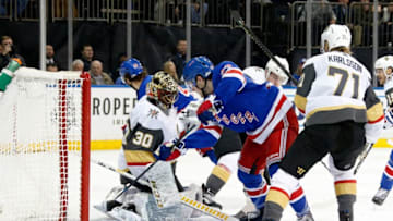NEW YORK, NY - DECEMBER 02: Adam Fox #23 of the New York Rangers battles for the puck as Malcolm Subban #30 of the Vegas Golden Knights makes a save at Madison Square Garden on December 2, 2019 in New York City. (Photo by Jared Silber/NHLI via Getty Images)