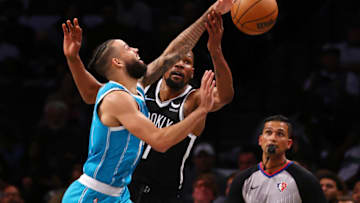 NEW YORK, NY - OCTOBER 24: Cody Martin #11 of the Charlotte Hornets beats Kevin Durant #7 of the Brooklyn Nets to a loose ball during the second half of a game at Barclays Center on October 24, 2021 in New York City. The Hornets defeated the Nets 111-95.NOTE TO USER: User expressly acknowledges and agrees that, by downloading and or using this photograph, User is consenting to the terms and conditions of the Getty Images License Agreement. (Photo by Rich Schultz/Getty Images)