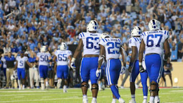 CHAPEL HILL, NORTH CAROLINA - OCTOBER 26: Temmates console Deon Jackson #25 of the Duke Blue Devils after an interception late in the fourth quarter giving the North Carolina Tar Heels a 20-17 victory at Kenan Stadium on October 26, 2019 in Chapel Hill, North Carolina. (Photo by Streeter Lecka/Getty Images)