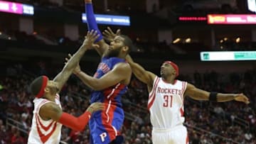 Mar 6, 2015; Houston, TX, USA; Detroit Pistons forward Greg Monroe (10) shoots the ball as Houston Rockets guard Jason Terry (31) defends in the second half at Toyota Center. Mandatory Credit: Thomas B. Shea-USA TODAY Sports