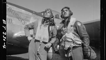 Col. Benjamin O. Davis (left), commanding officer of the 332nd Fighter Group, and Edward C. Gleed, group operations officer, stand in front of a plane in Ramitelli, Italy, in March 1945.