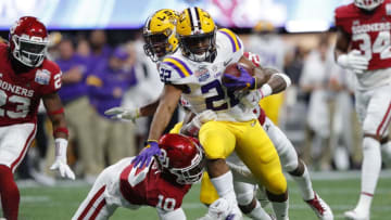 ATLANTA, GEORGIA - DECEMBER 28: Running back Clyde Edwards-Helaire #22 of the LSU Tigers carries the ball over wide receiver Theo Wease #10 of the Oklahoma Sooners during the Chick-fil-A Peach Bowl at Mercedes-Benz Stadium on December 28, 2019 in Atlanta, Georgia. (Photo by Kevin C. Cox/Getty Images)