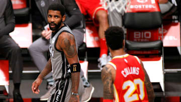 NEW YORK, NEW YORK - DECEMBER 30: Kyrie Irving #11 of the Brooklyn Nets reacts toward John Collins #20 of the Atlanta Hawks during the first half at Barclays Center on December 30, 2020 in the Brooklyn borough of New York City. NOTE TO USER: User expressly acknowledges and agrees that, by downloading and/or using this Photograph, user is consenting to the terms and conditions of the Getty Images License Agreement. (Photo by Sarah Stier/Getty Images)