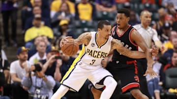 Apr 23, 2016; Indianapolis, IN, USA; Indiana Pacers guard George Hill (3) defended by Toronto Raptors guard Kyle Lowry (7) during the second half of game four of the first round of the 2016 NBA Playoffs at Bankers Life Fieldhouse. Indiana defeats Toronto 100-83. Mandatory Credit: Brian Spurlock-USA TODAY Sports