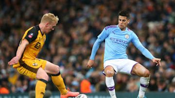 MANCHESTER, ENGLAND - JANUARY 04: Joao Cancelo of Manchester City battles for possession with Mark Cullen of Port Vale during the FA Cup Third Round match between Manchester City and Port Vale at Etihad Stadium on January 04, 2020 in Manchester, England. (Photo by Alex Livesey/Getty Images)