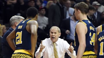 Mar 18, 2016; Brooklyn, NY, USA; Michigan Wolverines head coach John Beilein talks with guard Zak Irvin (21) and forward Mark Donnal (34) against the Notre Dame Fighting Irish in the second half in the first round of the 2016 NCAA Tournament at Barclays Center. Mandatory Credit: Anthony Gruppuso-USA TODAY Sports