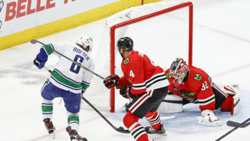 Oct 21, 2021; Chicago, Illinois, USA; Vancouver Canucks right wing Brock Boeser (6) scores against Chicago Blackhawks goaltender Kevin Lankinen (32) during the second period at United Center. Mandatory Credit: Kamil Krzaczynski-USA TODAY Sports