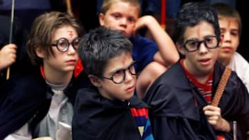 Harry Potter look-a-likes, Carly Smith, left, 10, of Goodlettsville, Jack, 7, and brother Will Chilcutt, 11, sit and listen to excerpts from various Harry Potter books at Books-A-Million near Rivergate July 7, 2000 during the prerelease activities of the latest book, "Harry Potter and the Goblet of Fire" Jack was one of three runners-up in the lookalike contest for the popular character.Harry Potter Book Sales