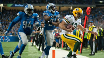 Dec 3, 2015; Detroit, MI, USA; Green Bay Packers quarterback Aaron Rodgers (12) scores a touchdown during the fourth quarter against the Detroit Lions at Ford Field. Green Bay won 27-23. Mandatory Credit: Tim Fuller-USA TODAY Sports