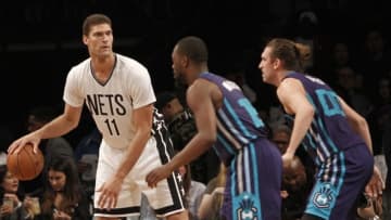 Nov 4, 2016; Brooklyn, NY, USA; Brooklyn Nets center Brook Lopez (11) looks to pass the ball against Charlotte Hornets guard Kemba Walker (15) and forward Spencer Hawes (00) in the second quarter at Barclays Center. Mandatory Credit: Nicole Sweet-USA TODAY Sports