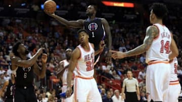 Feb 7, 2016; Miami, FL, USA; Los Angeles Clippers forward Lance Stephenson (1) drives to the basket as Miami Heat center Hassan Whiteside (21) defends during the first half at American Airlines Arena. Mandatory Credit: Steve Mitchell-USA TODAY Sports
