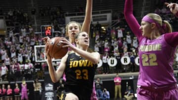 Jan 24, 2016; West Lafayette, IN, USA; Iowa Hawkeyes forward Christina Buttenham (23) drives past the defense of Purdue Boilermakers center Bree Horrocks (22) and guard Bridget Perry (13) in the first half at Mackey Arena. Mandatory Credit: Sandra Dukes-USA TODAY Sports