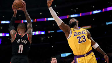 LOS ANGELES, CALIFORNIA - JANUARY 31: Damian Lillard #0 of the Portland Trail Blazers grabs a rebound in front of LeBron James #23 of the Los Angeles Lakers during the second half at Staples Center on January 31, 2020 in Los Angeles, California. (Photo by Harry How/Getty Images)