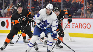 Apr 2, 2022; Philadelphia, Pennsylvania, USA; Toronto Maple Leafs right wing Ilya Mikheyev (65) controls the puck against Philadelphia Flyers defenseman Ronnie Attard (47) and right wing Owen Tippett (74) during the third period at Wells Fargo Center. Mandatory Credit: Eric Hartline-USA TODAY Sports