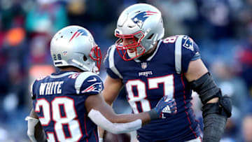 FOXBOROUGH, MASSACHUSETTS - JANUARY 13: James White #28 of the New England Patriots reacts with Rob Gronkowski #87 during the third quarter in the AFC Divisional Playoff Game against the Los Angeles Chargers at Gillette Stadium on January 13, 2019 in Foxborough, Massachusetts. (Photo by Adam Glanzman/Getty Images)