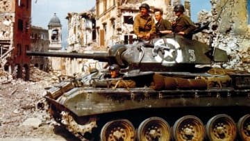 U.S. soldiers in an M24 Chaffee light tank driving through Bologna, Italy, in 1945.