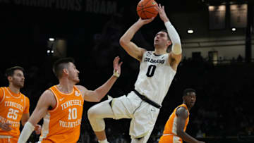 Dec 4, 2021; Boulder, Colorado, USA; Colorado Buffaloes guard Luke O'Brien (0) shoots over Tennessee Volunteers forward John Fulkerson (10) in the first half at CU Events Center. Mandatory Credit: Ron Chenoy-USA TODAY Sports