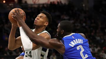 Giannis Antetokounmpo #34 of the Milwaukee Bucks is fouled by Eugene Omoruyi #2 of the Dallas Mavericks during the first half of a game at Fiserv Forum on October 15, 2021 in Milwaukee, Wisconsin. (Photo by Stacy Revere/Getty Images)
