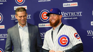 New Chicago Cubs pitcher Craig Kimbrel puts on his new jersey and hat after being introduced by Chicago Cubs President Theo Epstein at Wrigley Field in Chicago on Friday, June 7, 2019. (Jose M. Osorio/Chicago Tribune/TNS via Getty Images)