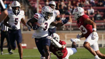 STANFORD, CALIFORNIA - SEPTEMBER 23: Jonah Coleman #3 of the Arizona Wildcats runs with the ball as Collin Wright #6 of the Stanford Cardinal attempts the tackle during the first half of the game at Stanford Stadium on September 23, 2023 in Stanford, California. (Photo by Loren Elliott/Getty Images)