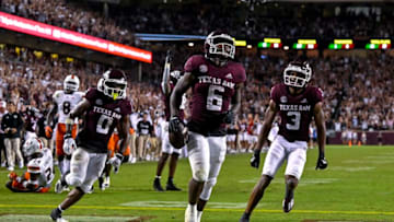Sep 17, 2022; College Station, Texas, USA; Texas A&M Aggies running back Devon Achane (6) scores a touchdown against the Miami Hurricanes as wide receiver Ainias Smith (0) and wide receiver Devin Price (3) celebrate in the end zone during the second half at Kyle Field. Mandatory Credit: Jerome Miron-USA TODAY Sports