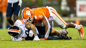 Oct 3, 2020; Clemson, South Carolina, USA; Clemson linebacker Mike Jones Jr. (6) tackles Virginia half back Billy Kemp IV (4) during their game at Memorial Stadium. Mandatory Credit: Ken Ruinard-USA TODAY Sports