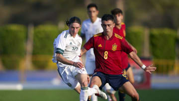 BENIDORM, SPAIN - SEPTEMBER 03: Marcelo Flores of Mexico runs with the ball under pressure from Saul Zamora of Spain during the International friendly match between Spain U19 and Mexico U19 at Estadio Camilo Cano on September 03, 2021 in Benidorm, Spain. (Photo by Manuel Queimadelos/Quality Sport Images/Getty Images)