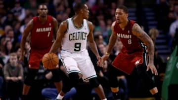 Mar 19, 2014; Boston, MA, USA; Boston Celtics point guard Rajon Rondo (9) dribbles the ball as Miami Heat forward Michael Beasley (8) defends during the third quarter at TD Garden. Mandatory Credit: Greg M. Cooper-USA TODAY Sports