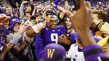 Sep 17, 2022; Seattle, Washington, USA; Washington Huskies quarterback Michael Penix Jr. (9) celebrates with fans following a 39-28 victory against the Michigan State Spartans at Alaska Airlines Field at Husky Stadium. Mandatory Credit: Joe Nicholson-USA TODAY Sports