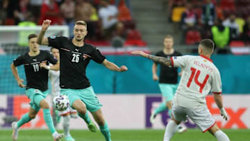 Austria's forward Sasa Kalajdzic (L) challenges North Macedonia's defender Darko Velkovski during the UEFA EURO 2020 Group C football match between Austria and North Macedonia at the National Arena in Bucharest on June 13, 2021. (Photo by MARKO DJURICA / POOL / AFP) (Photo by MARKO DJURICA/POOL/AFP via Getty Images)