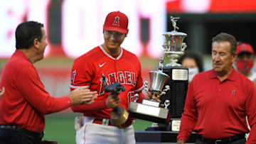 ANAHEIM, CA - SEPTEMBER 25: General Manager Perry Minasian, left, applauds Shohei Ohtani while Los Angeles Angels Owner Arte Moreno waits to give him the Angels Most Valuable Player award before playing the Seattle Mariners at Angel Stadium of Anaheim on September 25, 2021 in Anaheim, California. (Photo by John McCoy/Getty Images)