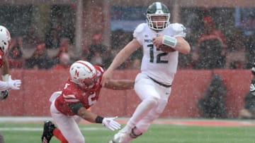 LINCOLN, NE - NOVEMBER 17: Quarterback Rocky Lombardi #12 of the Michigan State Spartans runs from linebacker Dedrick Young II #5 of the Nebraska Cornhuskers in the second half at Memorial Stadium on November 17, 2018 in Lincoln, Nebraska. (Photo by Steven Branscombe/Getty Images)