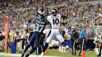 Aug 17, 2013; Seattle, WA, USA; Seattle Seahawks defensive back Will Blackmon (37) breaks up a pass in the end zone intended for Denver Broncos wide receiver Gerell Robinson (10) during the 2nd half at CenturyLink Field. Seattle defeated Denver 40-10. Mandatory Credit: Steven Bisig-USA TODAY Sports