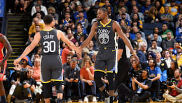 OAKLAND, CA - OCTOBER 31: Stephen Curry #30 and Kevin Durant #35 of the Golden State Warriors high five during the game against the New Orleans Pelicans on October 31, 2018 at ORACLE Arena in Oakland, California. NOTE TO USER: User expressly acknowledges and agrees that, by downloading and/or using this photograph, user is consenting to the terms and conditions of Getty Images License Agreement. Mandatory Copyright Notice: Copyright 2018 NBAE (Photo by Noah Graham/NBAE via Getty Images)