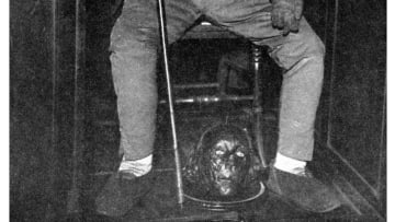 Jeremy Bentham's preserved head between the feet of his auto-icon, circa the 1950s.