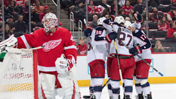 DETROIT, MI - NOVEMBER 26: Boone Jenner #38 of the Columbus Blue Jackets celebrates his second period goal with teammates Ryan Murray #27 and Brandon Dubinsky #17 in front of goaltender Jonathan Bernier #45 of the Detroit Red Wings during an NHL game at Little Caesars Arena on November 26, 2018 in Detroit, Michigan. (Photo by Dave Reginek/NHLI via Getty Images)