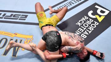 LAS VEGAS, NEVADA - AUGUST 15: (R-L) Daniel Pineda elbows Herbert Burns of Brazil in their featherweight bout during the UFC 252 event at UFC APEX on August 15, 2020 in Las Vegas, Nevada. (Photo by Jeff Bottari/Zuffa LLC)