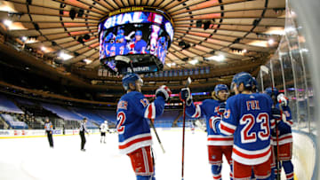 Julien Gauthier #12 of the New York Rangers high-fives Brendan Lemieux #48 and Adam Fox #23 Mandatory Credit: Sarah Stier/POOL PHOTOS-USA TODAY Sports