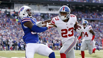 Oct 4, 2015; Orchard Park, NY, USA; New York Giants running back Rashad Jennings (23) stiff arms Buffalo Bills strong safety Bacarri Rambo (30) as he runs for a touchdown during the second half at Ralph Wilson Stadium. Giants beat the Bills 24-10. Mandatory Credit: Kevin Hoffman-USA TODAY Sports